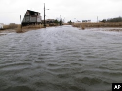 FILE - This March 14, 2017, photo shows the flooded streets of a back bay neighborhood in Manahawkin, N.J., after a moderate storm.