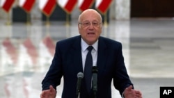 FILE - Lebanese Prime Minister-designate Najib Mikati speaks to journalists after his meeting with Lebanese President Michel Aoun, at the Presidential Palace in Baabda, east of Beirut, Lebanon, July 26, 2021.