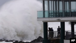 People watch as huge swells hit the beaches on the Gold Coast, Australia, March 6, 2025.