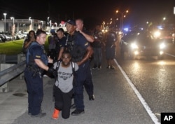 Police arrest Black Lives Matter leader DeRay McKesson during a protest along Airline Highway, a major road that passes in front of the Baton Rouge Police Department headquarters, July 9, 2016, in Baton Rouge, Louisiana.