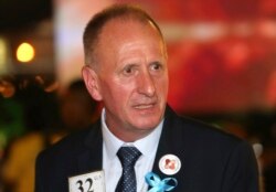FILE- British cave expert Vernon Unsworth talks with guests at an event in Bangkok, Thailand, Sept. 6, 2018.