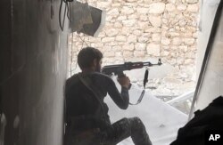 FILE - This undated file photo posted Nov. 4, 2014, by the Raqqa Media Office of the Islamic State group, a militant extremist group, shows an Islamic State fighter in Kobani, Syria.