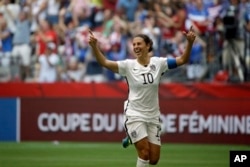 United States' Carli Lloyd celebrates after scoring her third goal against Japan during the first half of the FIFA Women's World Cup soccer championship in Vancouver, British Columbia, Canada, Sunday, July 5, 2015. (AP Photo/Elaine Thompson)