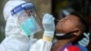 A medical worker performs a nose swab on a migrant boy at a seafood market, amid the coronavirus disease (COVID-19) outbreak, in Samut Sakhon province, in Thailand, December 19, 2020. REUTERS/Panumas Sa