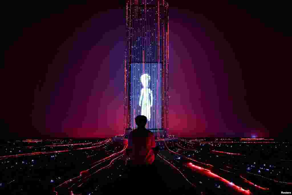 A man sits attends "The Little Prince Universe &mdash; An Immersive Journey," a show of mixed digital interactive experiences and installations, based on Antoine de Saint-Exupery's novella "The Little Prince," in Bangkok, Thailand.