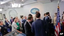 Reporters line up in hopes of attending a briefing in Press Secretary Sean Spicer's office at the White House in Washington, Feb. 24, 2017. White House held an off camera briefing in Spicer's office, where they selected who could attend.