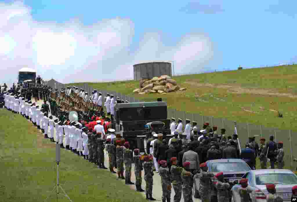 Military personnel line the route as former South African President Nelson Mandela's casket is taken to its burial place in Qunu. 