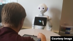 Researchers at Carnegie Mellon University have demonstrated that people who play a game with a robot suffer in performance when the robot criticizes them. (Carnegie Mellon University)