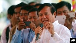 FILE: Cambodian Vice President of the National Assembly Kem Sokha, also vice president of Cambodia National Rescue Party, foreground, delivers a speech during a Buddhist ceremony to mark 18th anniversary in Phnom Penh, Cambodia, Monday, March 30, 2015.