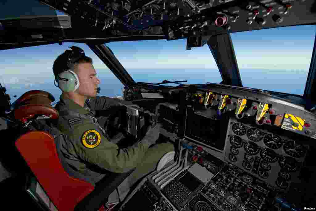 A Royal Australian Air Force pilot steers his AP-3C Orion over the southern Indian Ocean during the search for missing Malaysia Airlines flight MH370 in this picture released by the Australian Defense Force, March 20, 2014.