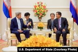 FILE - U.S. Secretary of State John Kerry, left, addresses Cambodian Prime Minister Hun Sen at the outset of a bilateral meeting at the Peace Palace in Phnom Penh, Cambodia, Jan. 26, 2016.