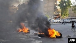 A handout picture released by the Syrian opposition's Shaam News Network on July 17, 2012 shows opponents of the regime blocking the roads with burning tires in Damascus on July 16, 2012.
