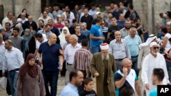 FILE - Palestinian Muslim worshippers walk in Jerusalem's Old City after Friday prayers, Oct. 23, 2015.