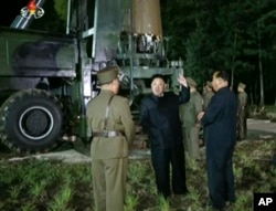 FILE - In this image made from video by North Korea's KRT on Friday, July 28, 2017, North Korean leader Kim Jung Un, center, gestures at the site of a missile test at an undisclosed location in North Korea.