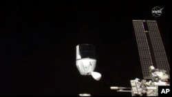 FILE- This photo provided by NASA shows SpaceX's Dragon undocking from International Space Station on Tuesday, Jan. 12, 2021. 
