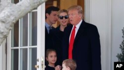 FILE - President Donald Trump and his family, daughter Ivanka Trump, her husband senior adviser Jared Kushner walks out of the Oval Office of the White House.