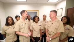 A screen grab from the U.S. Navy's Facebook Live event on Tuesday, July 10, 2018. Chief of Naval Operations Adm. John Richardson is joined by servicewomen for the announcement on policy changes regarding hairstyles. (Courtesy of U.S. Navy via AP)