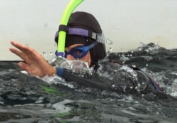 FILE - French swimmer Benoit Lecomte swims off the Brittany port of Quiberon at the end of his trans-Atlantic swim, September 25. Ben Lecomte left Cape Cod on July 16 to undertake the 5,400 kilometer swim aided by a yacht.