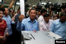 In this photo taken on July 29, 2018, Cambodia's Prime Minister and President of the Cambodian People's Party (CPP) Hun Sen prepares to cast his vote at a polling station during a general election in Takhmao, Kandal province, Cambodia.