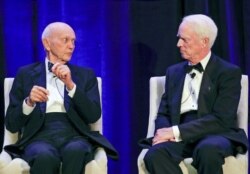 Apollo 11 astronaut Mike Collins makes comments as Rusty Schweickart, Apollo 9 astronaut listens during a news conference, July 16, 2019, in Cocoa Beach, Fla.