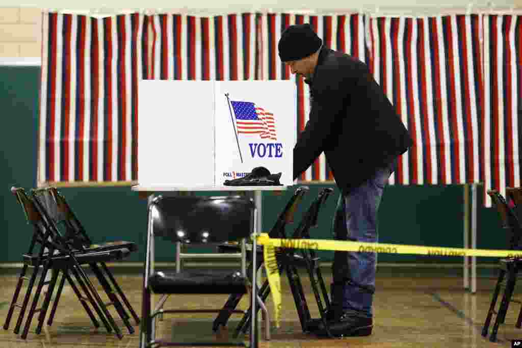 A voter marks his ballot in the first-in-the-nation presidential primary, Feb. 9, 2016, in Nashua, N.H.