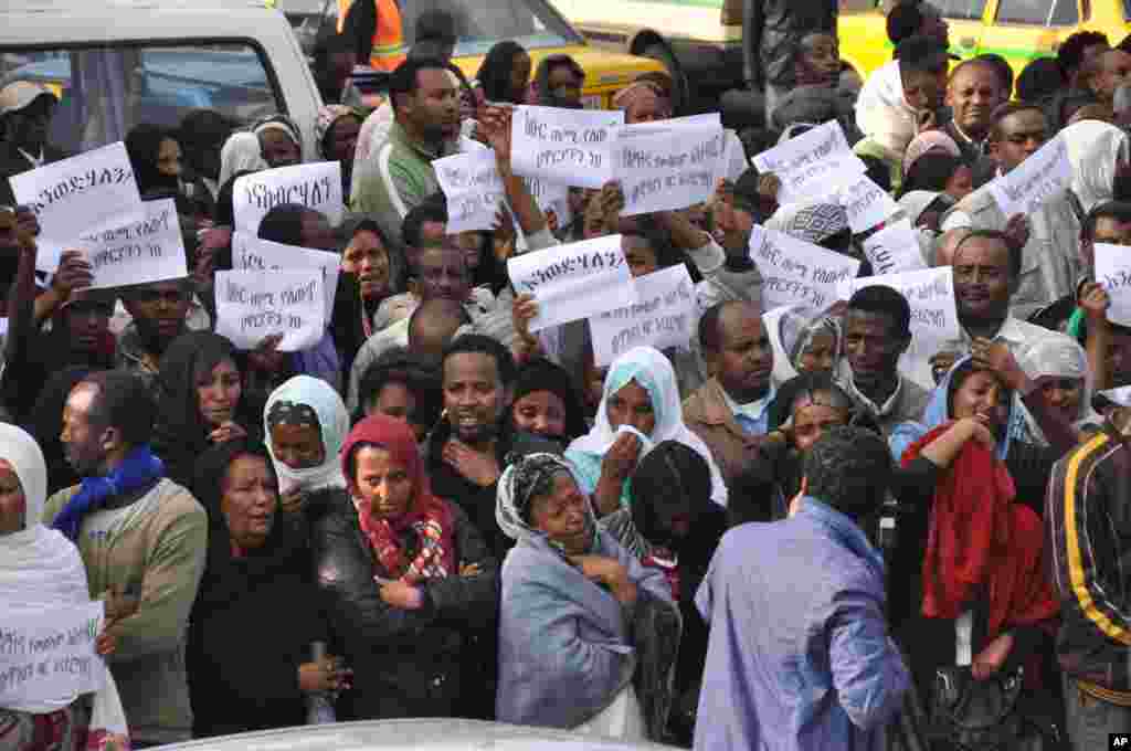 Ethiopians carry posters in Amharic reading "Meles We Love You" as they gather to mourn as the body of the late Prime Minister Meles Zenawi arrived in Addis Ababa, August 22, 2012. 