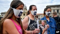 Members of the Noi Denunceremo (We will denounce) group arrive at a court in Bergamo, Italy, July 13, 2020.