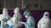 Healthcare workers get ready to collect samples during proactive testing of migrant workers at their work place, amid the spread of the COVID-19 outbreak in Samut Sakhon province in Thailand, Jan. 27, 2021.