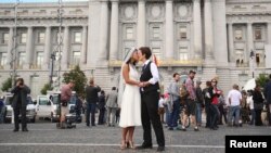 Lisa Dazols (R) and Jenny Chang celebrate after the U.S. Supreme Court ruled on California's Proposition 8 and the federal Defense of Marriage Act, outside the city hall in San Francisco, California, June 26, 2013. 