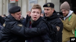 FILE - Belarus police detain journalist Raman Pratasevich, center, in Minsk, March 26, 2017.