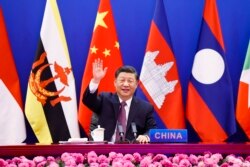 In this photo released by Xinhua News Agency, Chinese President Xi Jinping waves as he chairs the ASEAN-China Special Summit to commemorate the 30th Anniversary of ASEAN-China Dialogue Relations via video link from Beijing, China on Monday, Nov. 22, 2021.