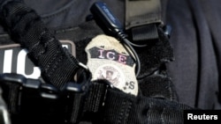 FILE - A U.S. Immigration and Customs Enforcement badge.