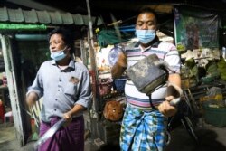 Local people bang pans the way they traditionally do it to drive away evil spirits, as they protest against military coup in Yangon, Myanmar February 3, 2021. REUTERS