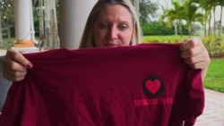 Felicia Burgin shows a commemorative T-shirt a group of fellow teachers made this year (Esha Sarai/VOA)