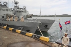 FILE - Cambodian navy troop members stand on a navy boat at Ream Naval Base in Sihanoukville, southwestern of Phnom Penh, Cambodia on July 26, 2019.