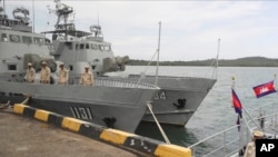 FILE - Cambodian navy troop members stand on a navy boat at Ream Naval Base in Sihanoukville, southwestern of Phnom Penh, Cambodia on July 26, 2019. (AP Photo/Heng Sinith)