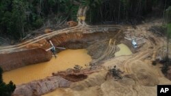 FILE - A Brazil Environmental Agency helicopter flies over an illegal mining camp during an operation to try to contain it in Yanomami Indigenous territory, Roraima state, Brazil, Feb. 11, 2023. (AP Photo/Edmar Barros, File)