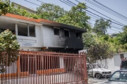 A charred car and building are pictured near the Petionville Police station where suspects of being involved in the assassination of President Jovenel Moise are being held, in Petionville, Haiti, July 9, 2021.