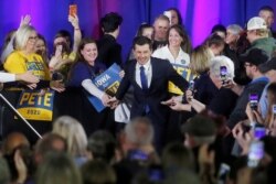 FILE - Democratic presidential candidate Pete Buttigieg greets attendees during a campaign event at a high school in Indianola, Iowa, Dec. 22, 2019.