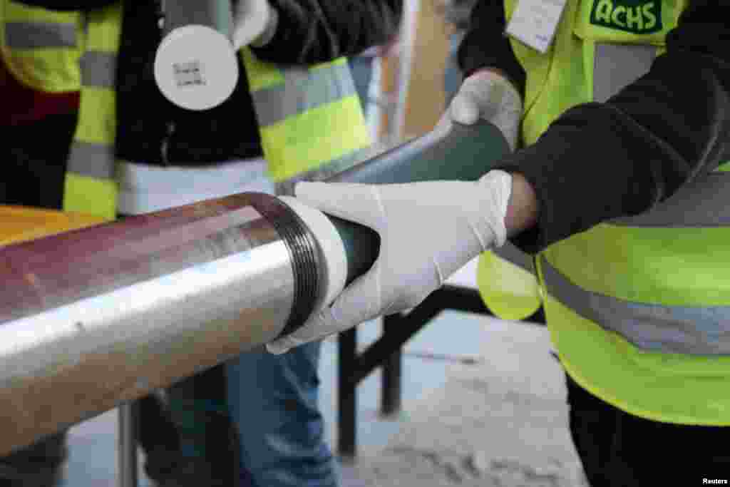 Workers load a tube used for sending supplies to 33 miners trapped in a deep underground copper and gold mine at Copiapo, north of Santiago, Chile, Sep. 9, 2010. The miners have been stuck in a tunnel 2,300 feet (700 metres) below ground for weeks after a cave-in. (Reuters)