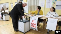 Voters cast their ballots in the European elections, and in Ireland's local elections and the divorce referendum at a polling station in Dublin, May 24, 2019.
