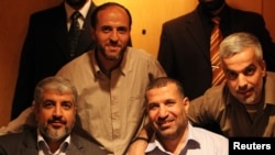 Top commander of Hamas armed wing Al-Qassam brigades, Ahmed Al-Jaabari, front right, pictured in Cairo, Oct. 18, 2011.
