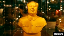 FILE - A golden bust of the late Chairman Mao Zedong, on display for sale at a Beijing department store.
