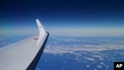 FILE - Japan Coast Guard's Gulfstream V aircraft flies in the search zone for debris from the missing Malaysia Airlines flight MH370.