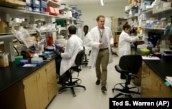 Dr. William Hahn, who is working on malaria research, walks through a research lab at the University of Washington's UW Medicine South Lake Union Campus.