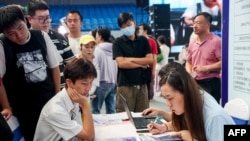 FILE - University graduates attend a job fair in Wuhan, in China's central Hubei province, Aug. 10, 2023. 