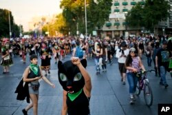 Women march against sexism and gender violence, in Santiago, Chile, Thursday, Nov. 22, 2018. (AP Photo/Esteban Felix)