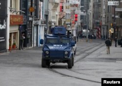 An armored police vehicle drives along an empty Istikal street, following a suicide bombing in a major shopping and tourist district in central Istanbul, March 19, 2016.