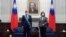 FILE - Taiwanese President Tsai Ing-wen, right poses for a photo after awarding a medal of honor to Alain Richard, the head of the French Senate's Taiwan Friendship Group, at the Presidential Office in Taipei, Taiwan, Oct. 7, 2021.