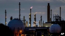 Chimneys and gas tanks are pictured on the BASF chemical plant in Ludwigshafen, Germany, Tuesday, Sept. 27, 2022. (AP Photo/Michael Probst)